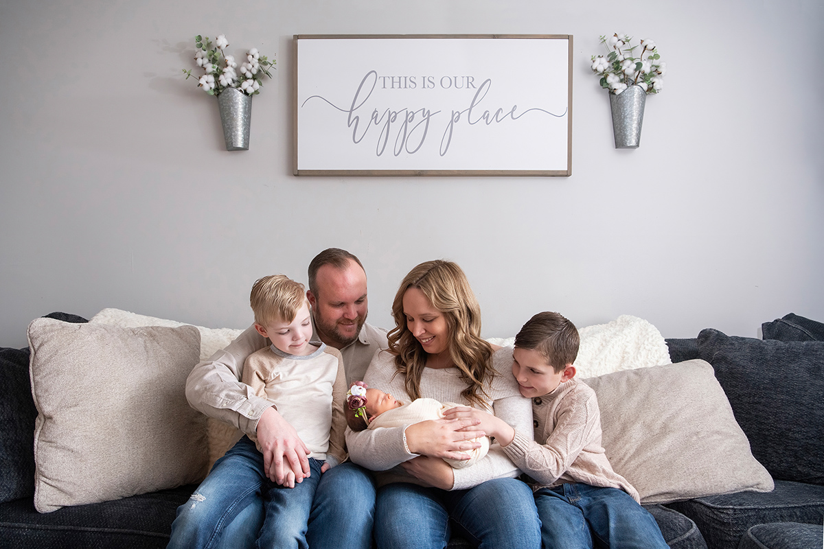 Family of five seated on a couch